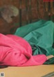 A pink sweater laying on top of a wooden table.